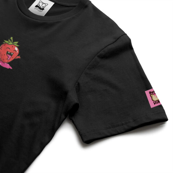 Donut Kitty Shelf Life: Detail of Black T-Shirt featuring Filled with Joy strawberry illustration